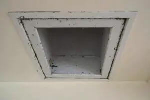 Before and after images of a cleaned residential air duct vent